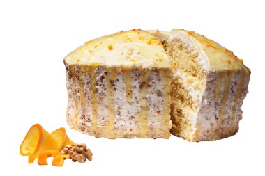 biscuit creamy cake glazed with translucent yellow glaze and decorated with shavings of orange peel with a cut out piece over white background. There are a pieces of orange and Walnut near. They are Isolated on white background, Side view.