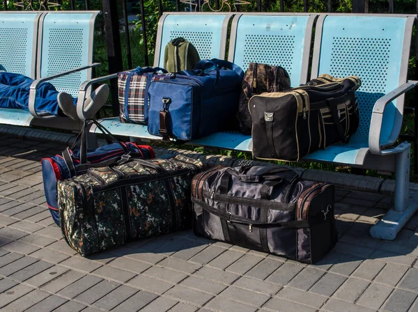 Bags, boxes and other luggage racks on the benches.