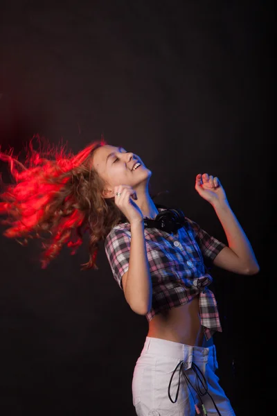 Teenage girl dancing on a black background — Stock Photo, Image