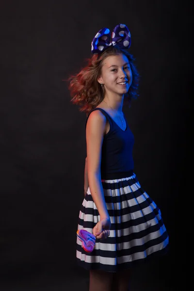 Teenage girl dancing on a black background — Stock Photo, Image