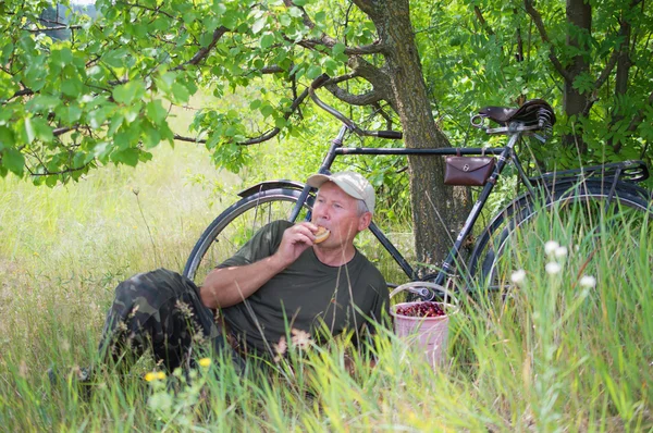 man with a bicycle resting