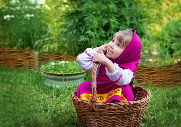 The girl in the costume of Masha village in the wicker basket — Stock Photo, Image
