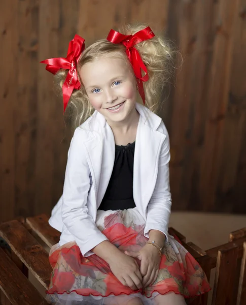 Smiling girl with bright red bows — Stock Photo, Image