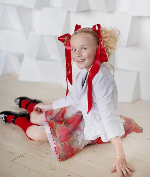 Smiling girl with red bows — Stock Photo, Image