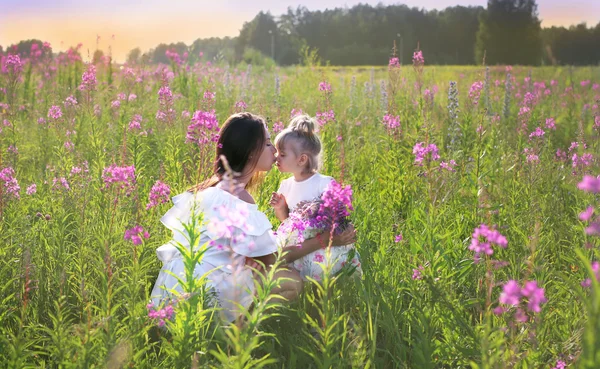 The girl sat down to the child, kisses him — Stock Photo, Image