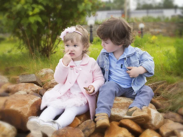 The boy looks at the girl sitting next — Stock Photo, Image