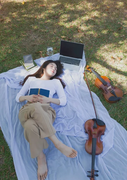 Genç Bayan Yeşil Çimlerin Üzerine Uzanmış Vücuduna Kitap Koyup Uyuyor — Stok fotoğraf