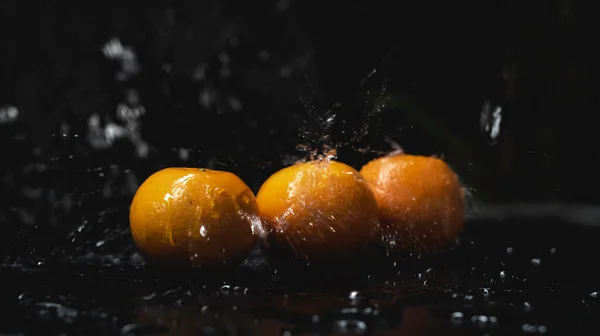 Orange fruit wet from water splashing,blurry light around