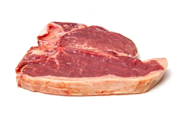 Bife T-bone isolado em um fundo de estúdio branco . — Fotografia de Stock