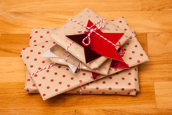 Gifts wrapped with paper on table — Stock Photo, Image