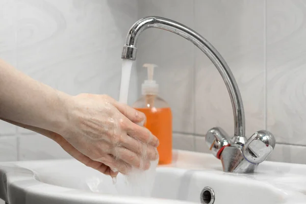 Wash hands with soap and hot water. Hand hygiene for coronavirus outbreak. Corona virus prevention