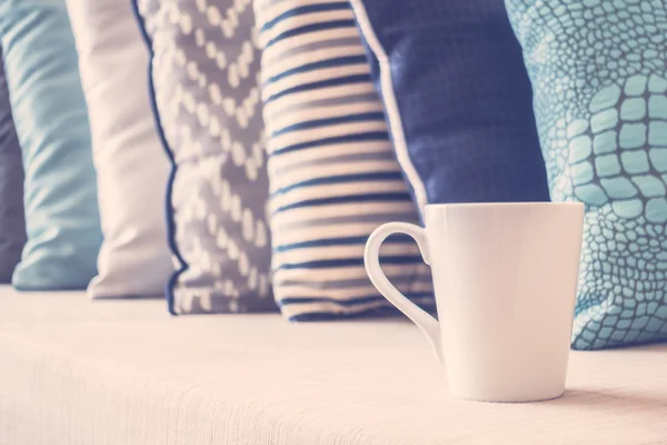 White coffee cups on sofa — Stock Photo, Image