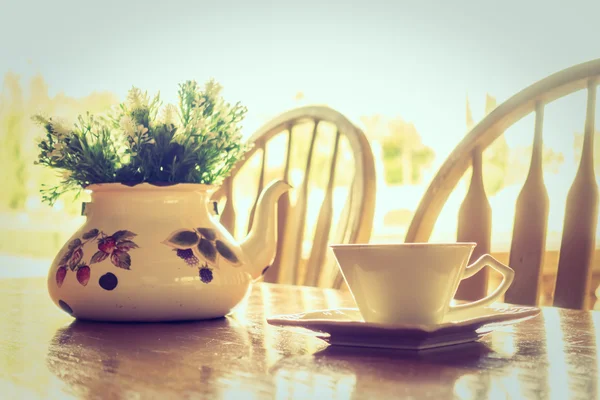 White coffee cup and vase plant