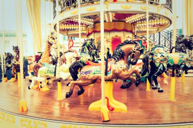 Vintage Carousel horse in amusement park clipart