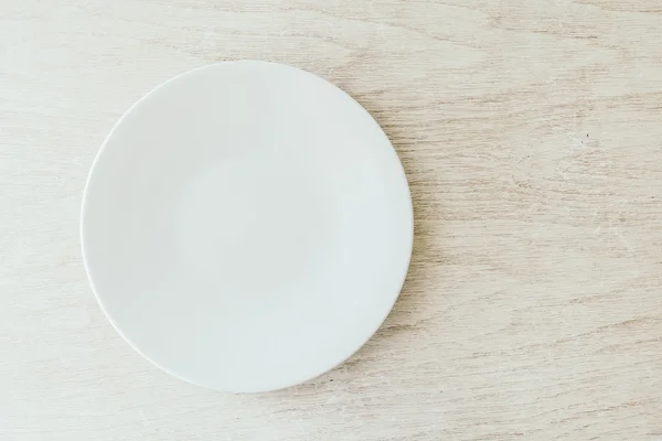 White plate on white wood background — Stock Photo, Image