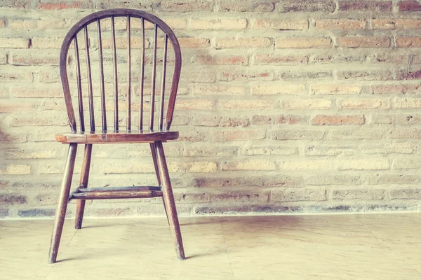 Wooden chair against wall