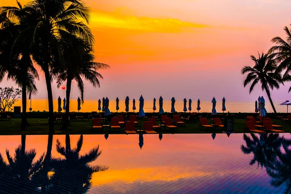 Silhouettes of palm trees on swimming pool