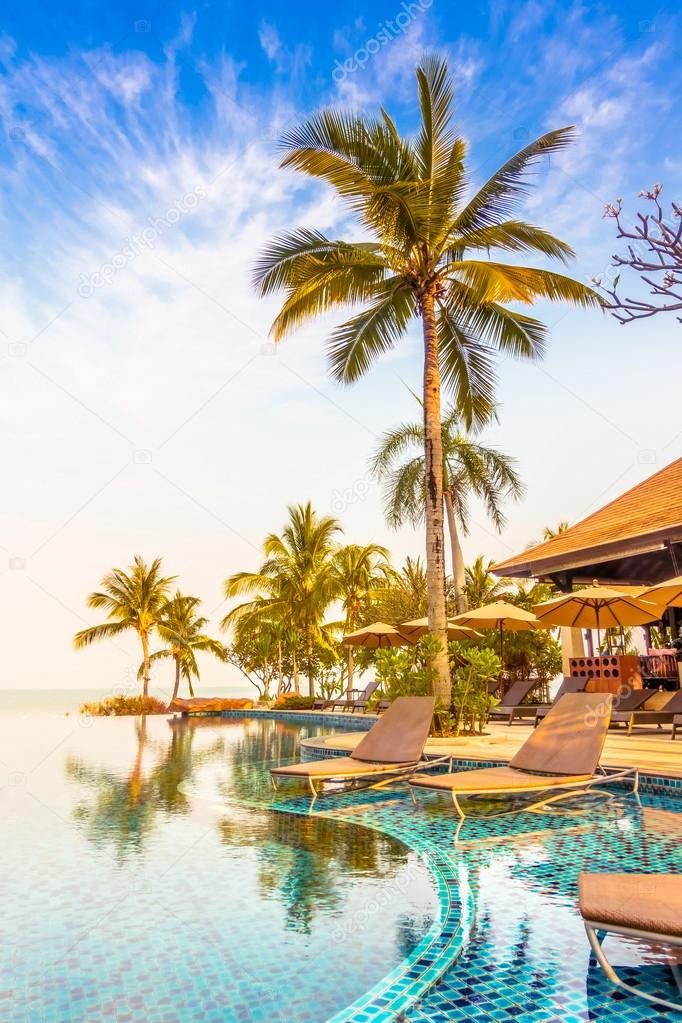 luxury swimming pool with palm trees