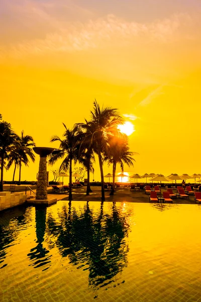 Silhouettes of palm trees on swimming pool