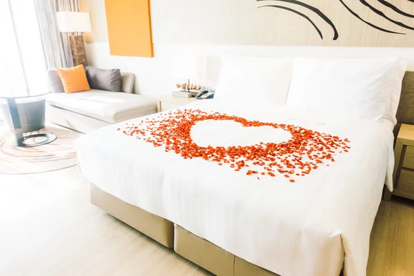 Oreillers blancs sur le lit et pétales de rose — Photo
