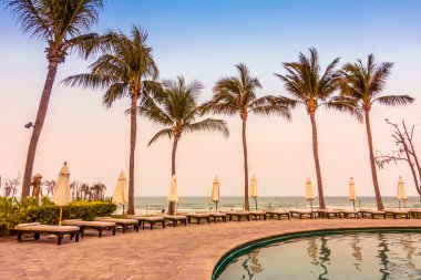 Şemsiyeleri ve sandalyeler Yüzme Havuzu etrafında