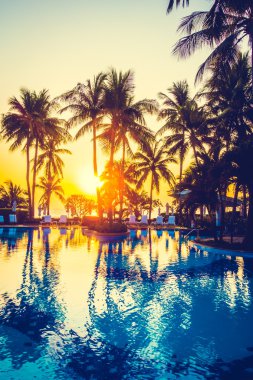 açık şemsiye ve havuz etrafında sandalyeler