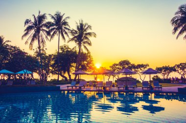 Şemsiye ile Hindistan cevizi hurma ağaçlarının Silhouettes