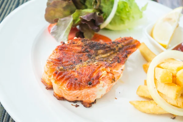 Salmon steak on white plate — Stock Photo, Image