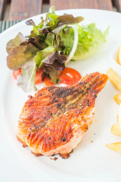 Salmon steak on white plate — Stock Photo, Image