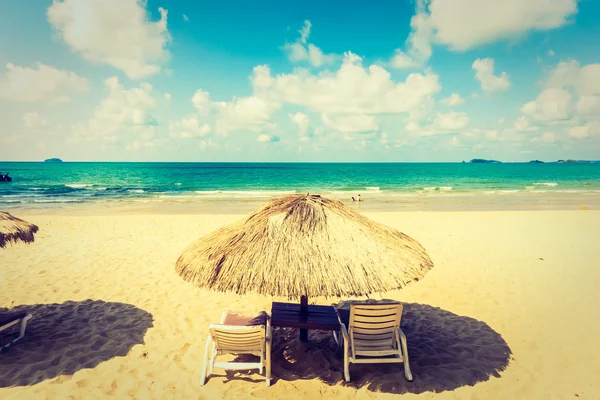 Sonnenschirm und Liegestuhl am Strand — Stockfoto