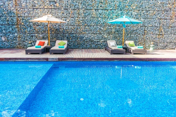 Umbrella and chair around swimming pool — Stock Photo, Image