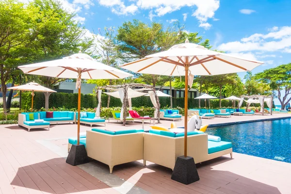 Umbrella and chair around swimming pool — Stock Photo, Image