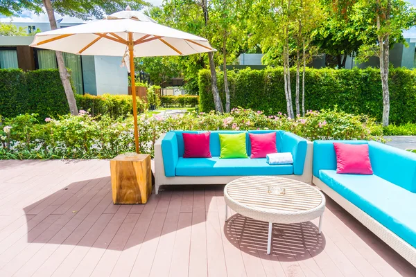 Umbrella and chair around swimming pool — Stock Photo, Image