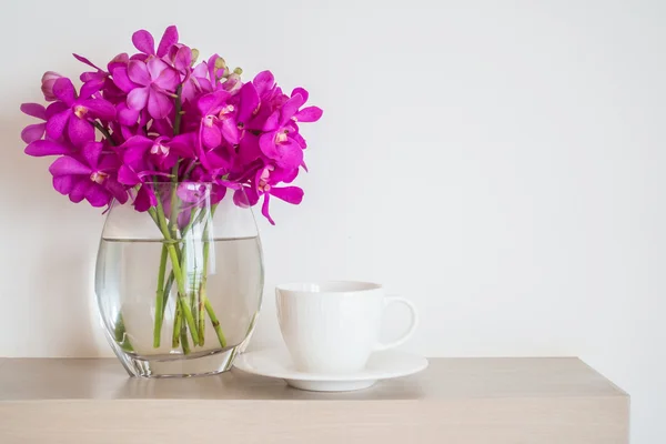 Coffee cup with orchid flower vase — Stock Photo, Image