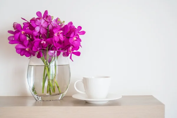 Coffee cup with orchid flower vase — Stock Photo, Image