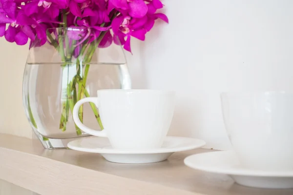 Coffee cup with orchid flower vase
