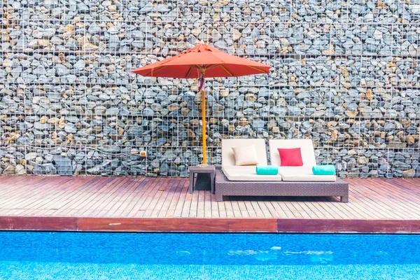 Umbrella and chair around swimming pool — Stock Photo, Image