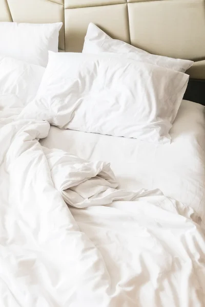 Rumpled bed with white messy pillow — Stock Photo, Image