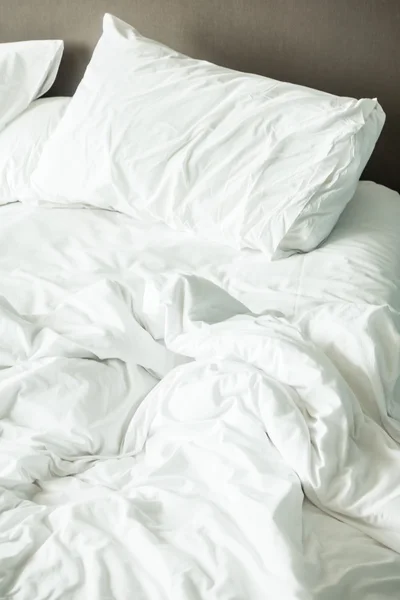 Rumpled bed in bedroom — Stock Photo, Image