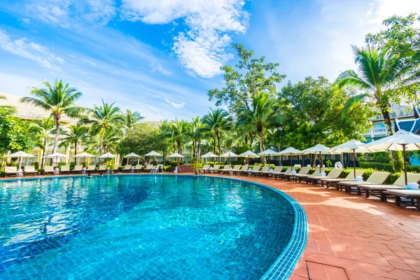 Umbrella and chair around swimming pool — Stock Photo, Image