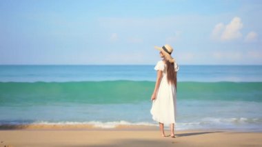 Güzel Asyalı kadının yaz tatilinde deniz kıyısında dinlendiği görüntüler.