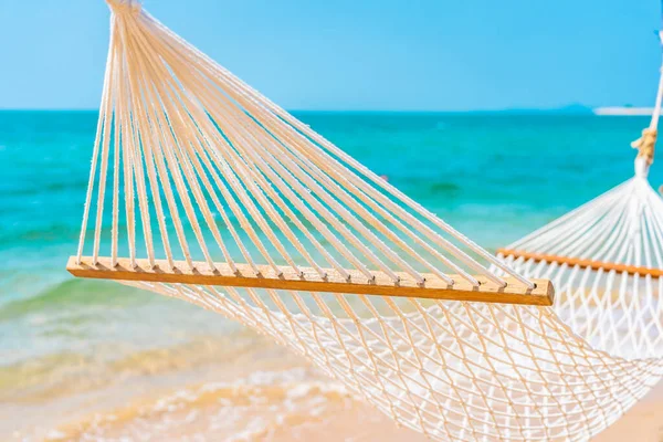 Empty white hammock around sea beach ocean for leisure travel vacation concept