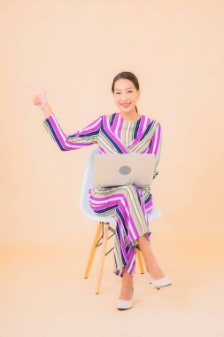 Bilgisayarlı güzel Asyalı kadın portresi. Renkli izole edilmiş arka plan.