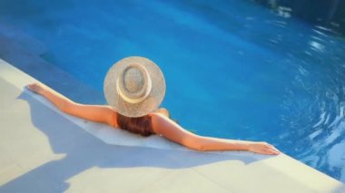 Havuzda dinlenen güzel bir Asyalı genç kadının görüntüleri.