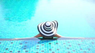 Havuzda dinlenen güzel bir Asyalı genç kadının görüntüleri.