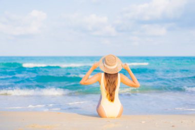 Güzel bir Asyalı kadının portresi. Rahatlayın. Plaj okyanusunda tatil yaparken gülümseyin.