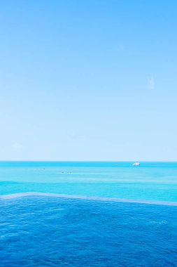 Deniz okyanusu, beyaz bulut ve seyahat için mavi gökyüzü manzaralı güzel sonsuzluk açık havuzu.