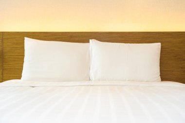 Yatak odasının iç dekorasyonuna beyaz yastık ve battaniye.