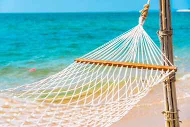 Boş bir tatil konsepti için deniz kıyısındaki boş bir hamak.