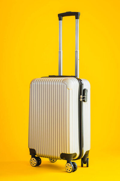Gray color luggage or baggage bag use for transportation travel and leisure on yellow isolated background